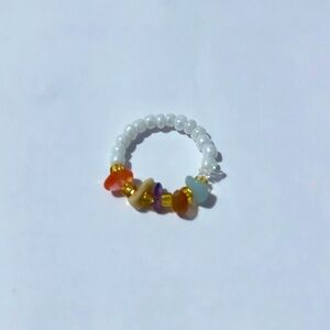 White beaded ring with crystal.